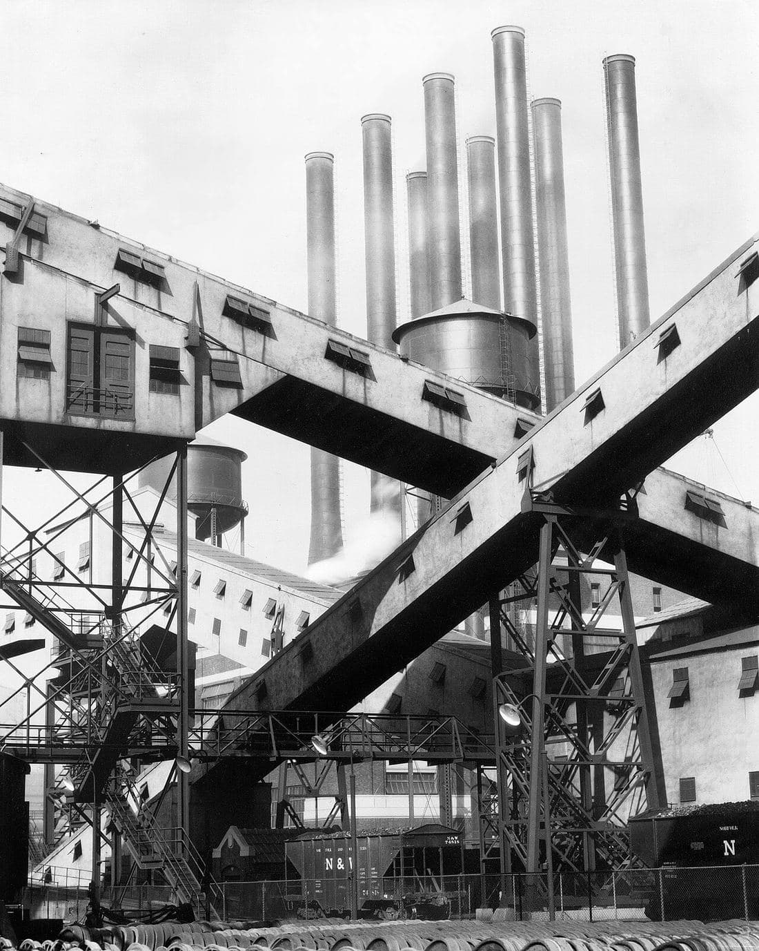 Charles Sheeler's 1927 photograph of crisscrossing conveyors linking buildings at the River Rouge plant.